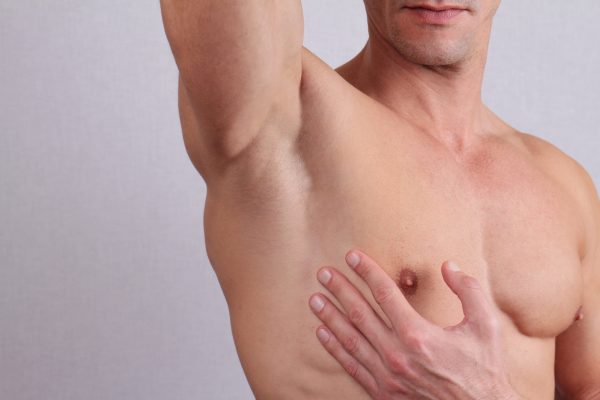 Close up of muscular male torso, chest and armpit hair removal. Male WaxingClose up of muscular male torso, chest and armpit hair removal. Male Waxing